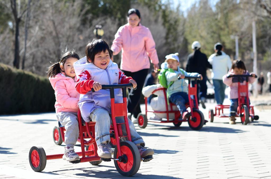 △2025年3月19日,在内蒙古鄂尔多斯康巴什区一所托育园,老师陪伴孩子做体能游戏。
